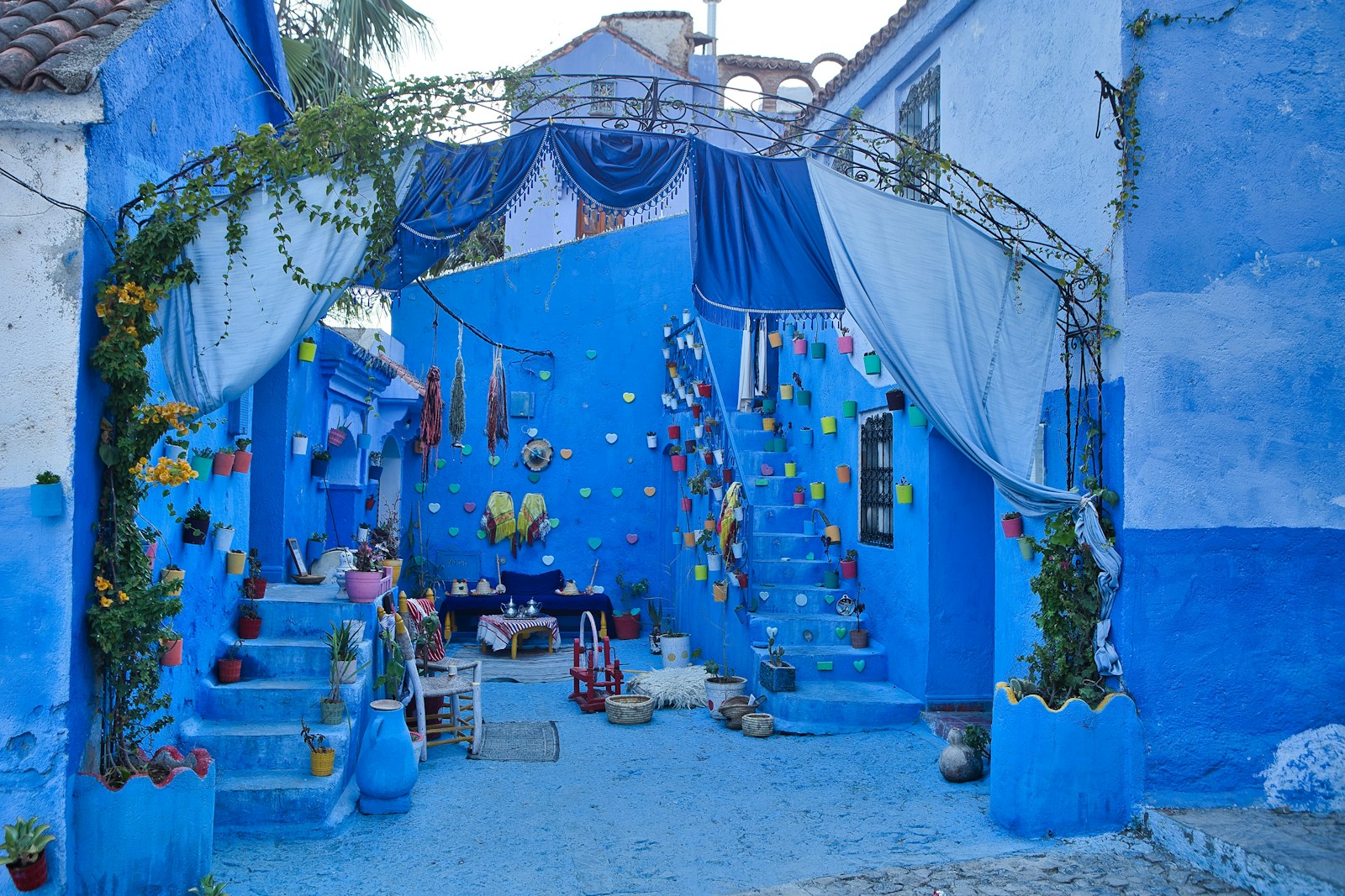 A narrow alley with blue walls and steps